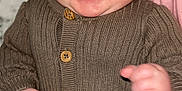 Lennox is registered to the contest to win money with this photo: baby, infant, smiling, happy, knitwear, hat, buttoned_sweater, fist, cozy, cute, child, face, indoors, blanket, portrait, closeup, skin, expression, young, warm
