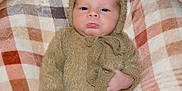 Lennox joined the competition — help win amazing prizes! baby, infant, costume, bear_ears, plaid_blanket, pouty_face, knitwear, cute, child, portrait, soft_texture, warm_clothing, snuggled, indoors, cozy, hands, face, expression, newborn, sleepy