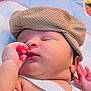 baby, sleeping, infant, hat, knit_cap, hand, face, skin, closeup, child, newborn, cute, peaceful, resting, soft_light, blanket, cushion, indoors, portrait, white_cloth