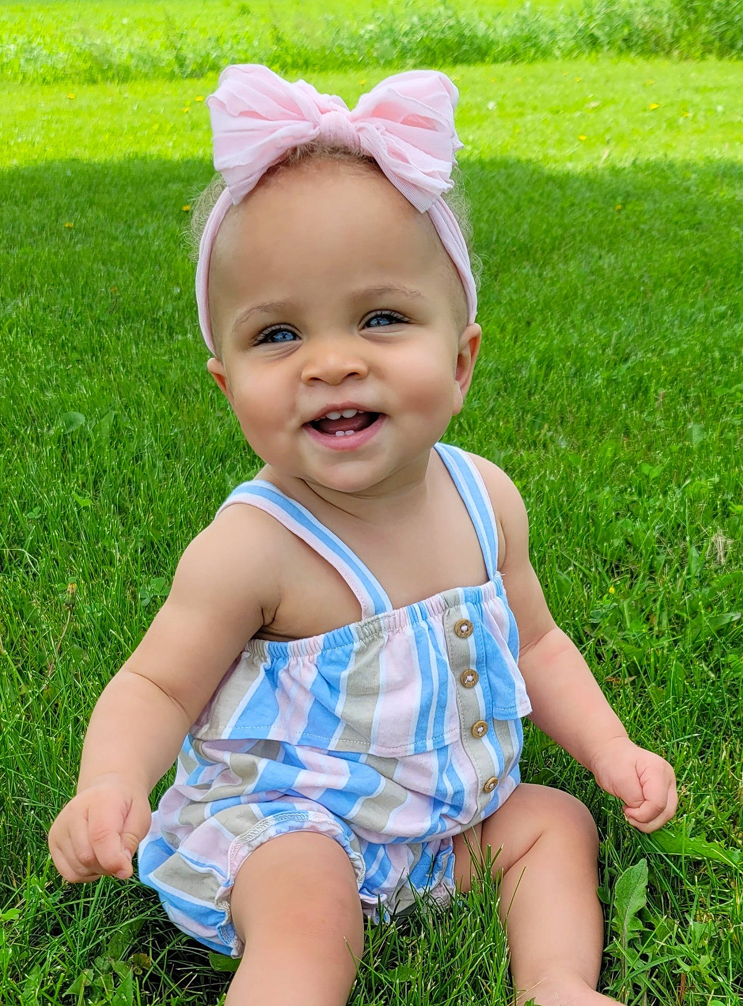 Emilah is registered to the contest to win money with this photo: baby, baby_toddler_clothing, child, eye, fun, grass, grass_family, green, happy, head, joy, lawn, meadow, pattern, people_in_nature, person, pink, plant, skin, smile