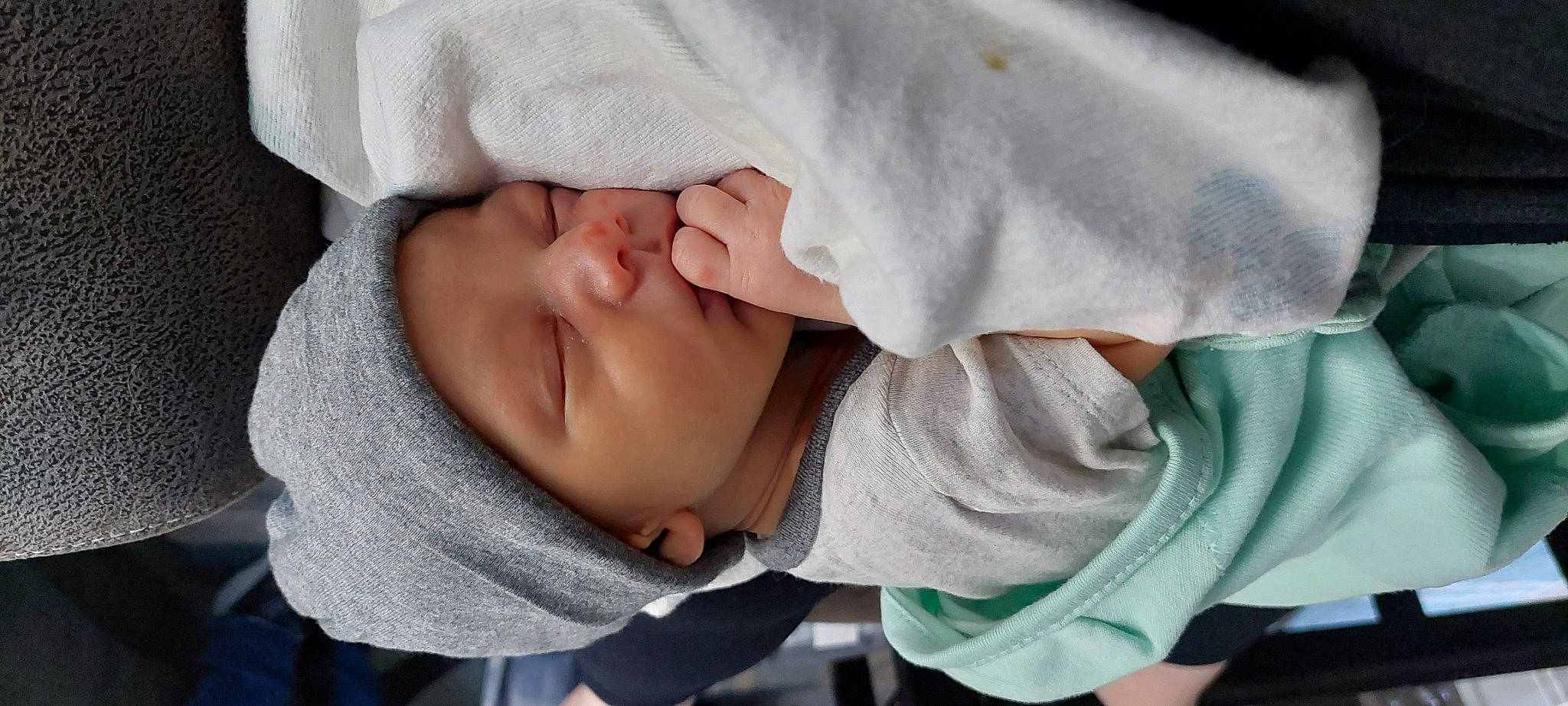 Josiah is registered to the contest to win money with this photo: baby, baby_toddler_clothing, cheek, child, comfort, finger, gesture, happy, headwear, linens, lip, mouth, nap, nose, outerwear, person, portrait_photography, sitting, skin, sleep