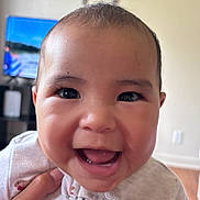 Lovella is registered to the contest to win money with this photo: baby, smile, face, happy, child, infant, closeup, person, indoors, cute, young, portrait, apparel, hand, skin, eyes, mouth, joy, expression, clothing