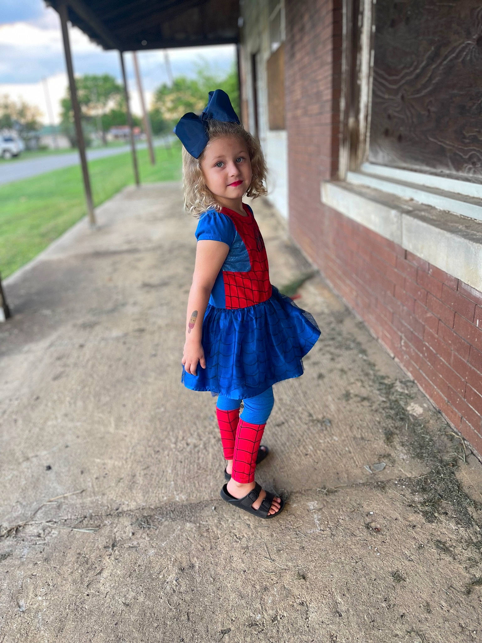 Kimber is registered to the contest to win money with this photo: asphalt, baby, baby_toddler_clothing, child, electric_blue, fun, grass, happy, hat, human_leg, joy, leisure, magenta, pattern, person, recreation, sandal, sun_hat, toddler, tree