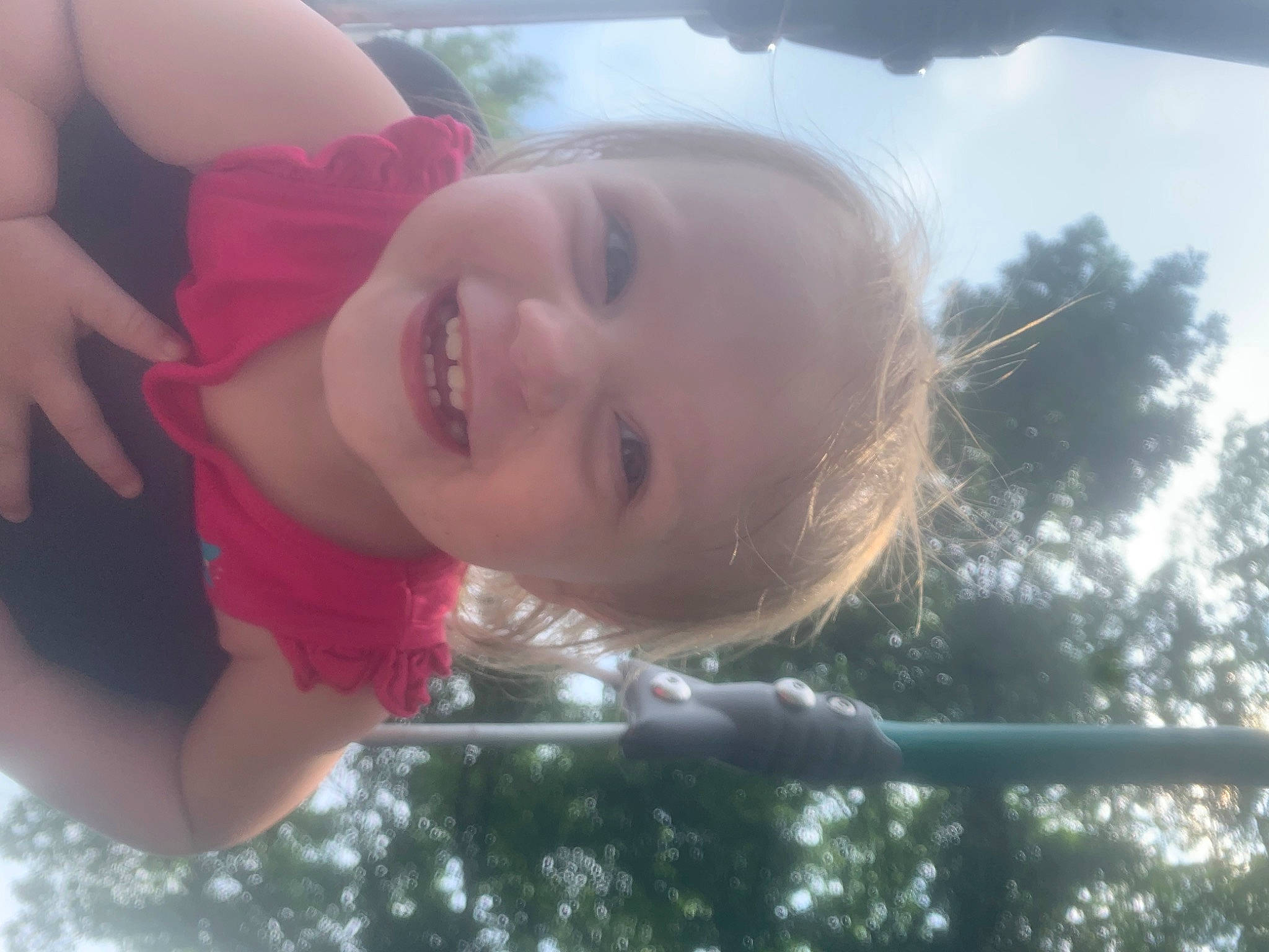 Ellie is registered to the contest to win money with this photo: baby, cheek, child, eyelash, facial_expression, fun, grass, happy, joy, leisure, lip, mouth, nose, person, pink, skin, sky, smile, sunlight, toddler