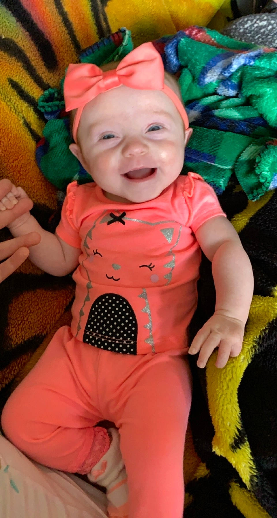 Ellie is registered to the contest to win money with this photo: baby, baby_toddler_clothing, cheek, cool, eye, facial_expression, finger, green, happy, head, headwear, human_body, mouth, organ, person, pink, product, skin, smile, standing