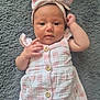 Lacey is registered to the contest to win money with this photo: baby, infant, child, dress, headband, pink, white, buttons, blanket, fuzzy, soft, cute, portrait, lying_down, hand, face, eyes, skin, indoor, newborn