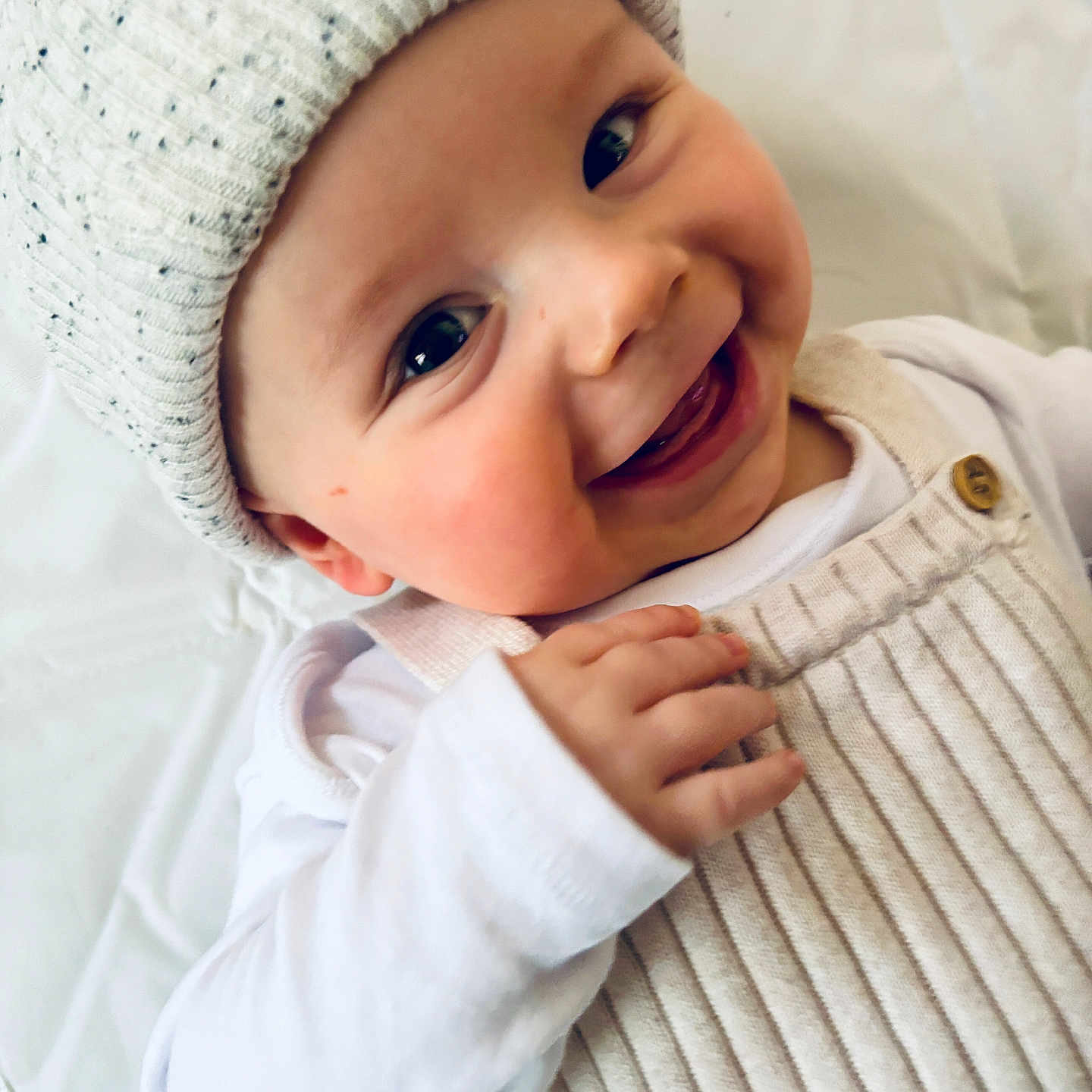 Joseph is registered to the contest to win money with this photo: baby, babylaughing, beanie, bodypart, bonnet, cap, clothing, face, finger, hand, happy, hat, head, hood, knitwear, laughing, newborn, person, photography, portrait