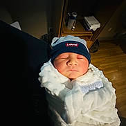 Eligh is registered to the contest to win money with this photo: accessories, architecture, baby, bag, bed, blanket, bonnet, building, cap, clothing, face, furniture, handbag, hat, head, newborn, person, photography, portrait, sleeping