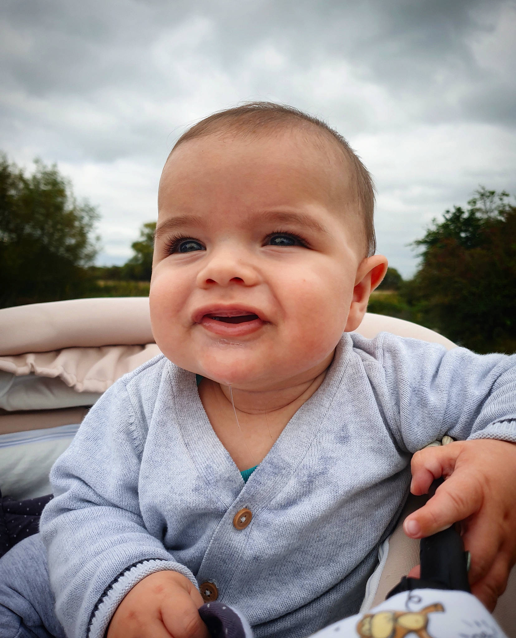 Matei is registered to the contest to win money with this photo: baby, baby_toddler_clothing, cheek, cloud, eye, face, facial_expression, finger, food_craving, grass, hand, happy, iris, joy, lip, mouth, nose, person, skin, sky