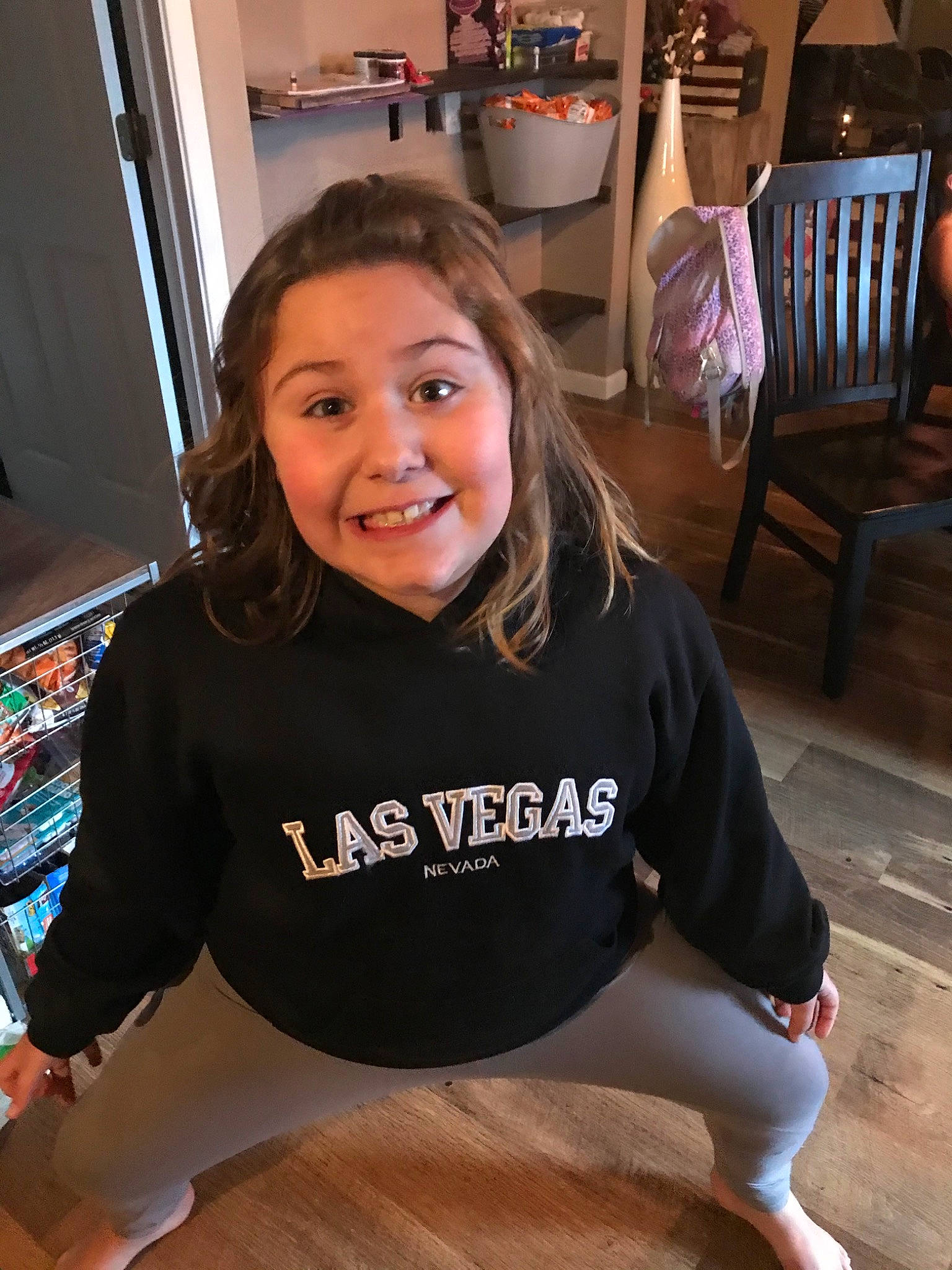 Brookelynn is registered to the contest to win money with this photo: arm, floor, flooring, hardwood, joint, joy, leg, person, shoulder, sitting, smile, sportswear, t_shirt, top, wood