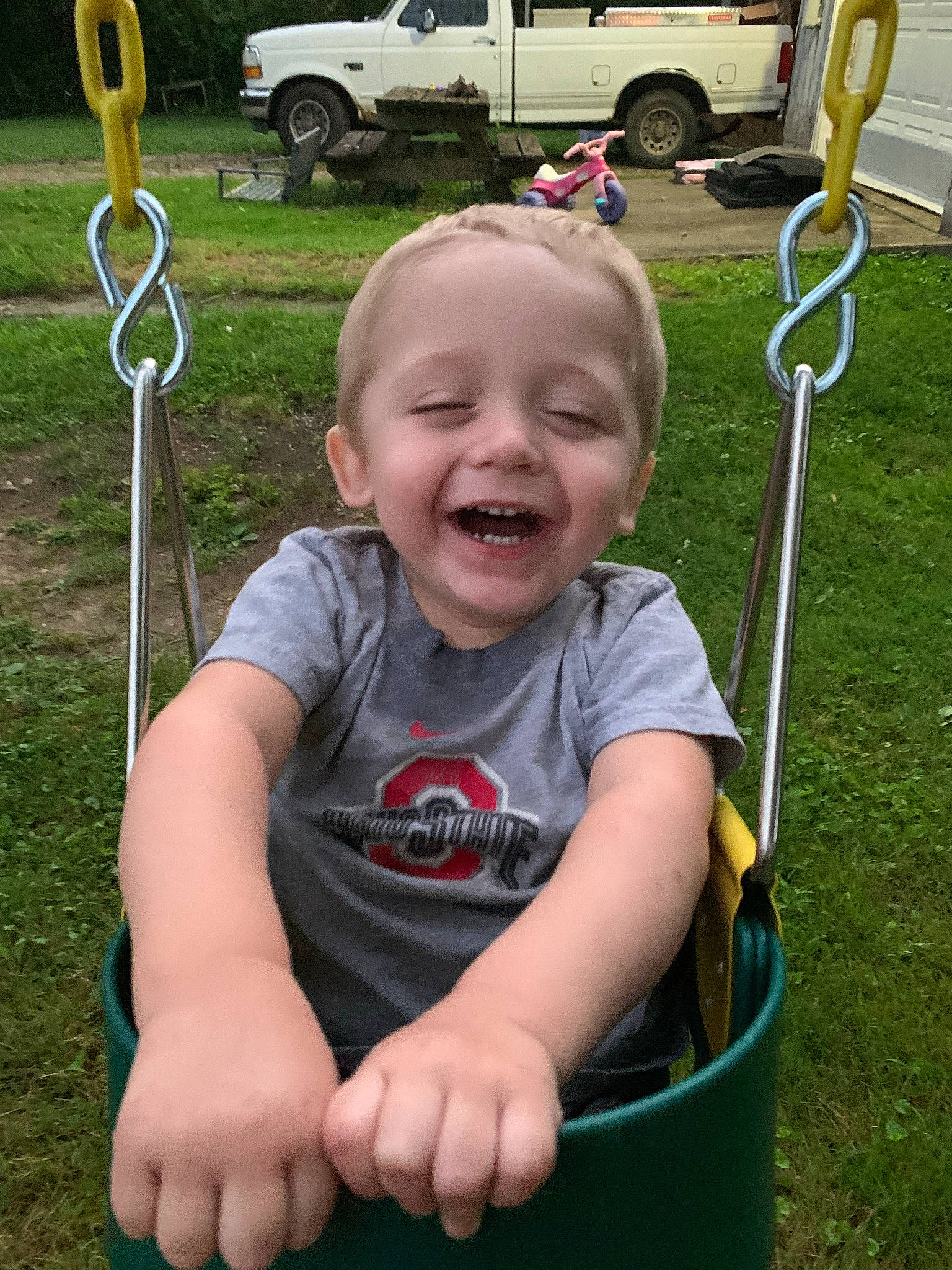Zephaniah joined the competition — help win amazing prizes! automotive_tire, baby, car, facial_expression, fun, grass, hand, leisure, mammal, person, plant, product, recreation, smile, swing, tire, toddler, truck, vehicle, wheel