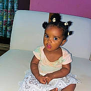 Lumaria Kiazi participe au concours pour gagner de l'argent avec cette photo : baby, child, curly_hair, curtains, cute, expression, face, furniture, hair_puffs, indoor, lace_skirt, pastel_clothing, person, pink_wall, portrait, sitting, toddler, white_couch, wooden_floor, young_child