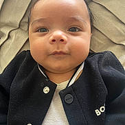 Elyam participe au concours pour gagner de l'argent avec cette photo : baby, infant, child, face, eyes, cheeks, nose, mouth, hair, blanket, jacket, button, clothing, portrait, closeup, skin, collar, cozy, gaze, lying_down