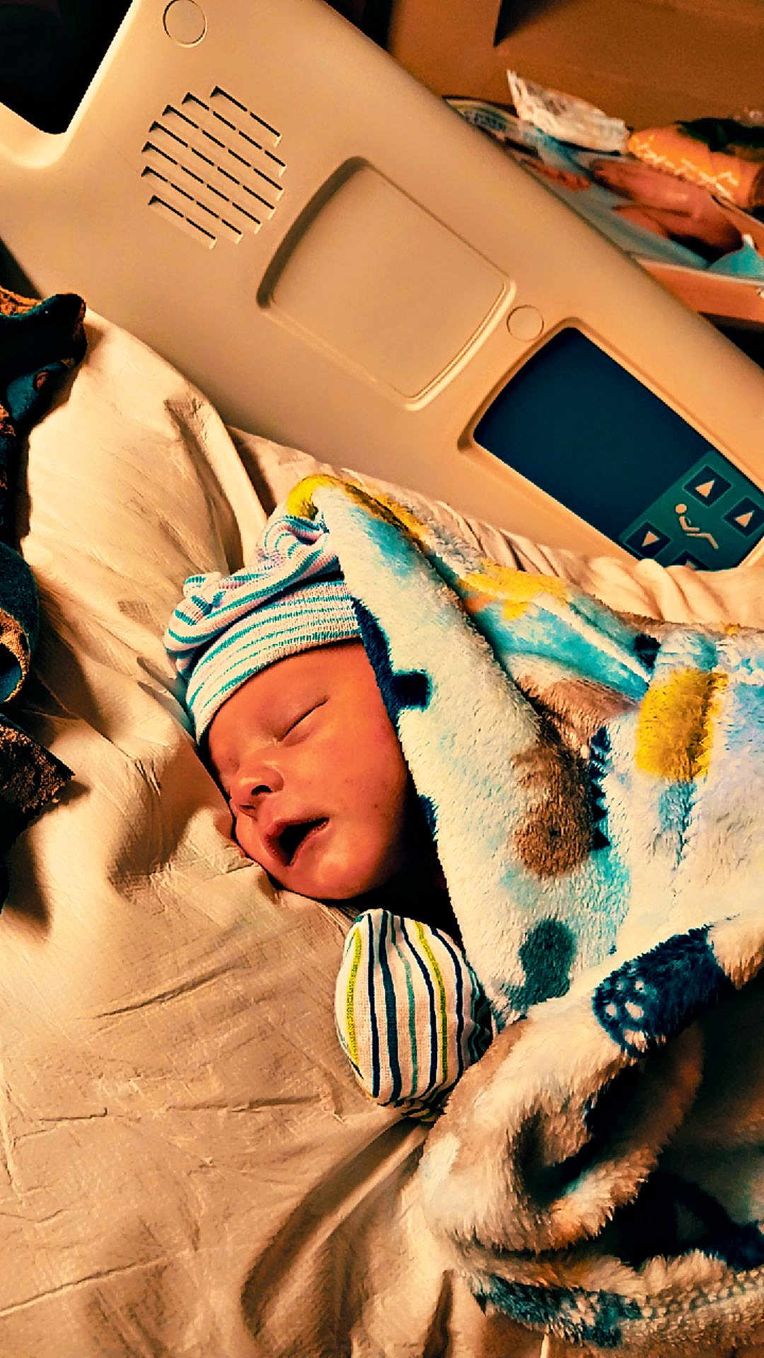 Secil is registered to the contest to win money with this photo: baby, bed, blanket, child, comfort, cute, face, hat, healthcare, hospital_bed, indoors, infant, newborn, peaceful, person, resting, sleeping, soft, striped, wrapped
