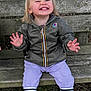 toddler, child, smile, laughing, jacket, boots, bench, outdoor, grass, wood, nature, person, happy, clothing, pants, face, hair, sitting, expression, park