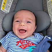 Sonny joined the competition — help win amazing prizes! baby, blue_eyes, car_seat, child, close_up, face, happy, head, indoor, infant, laughing, onesie, pacifier, portrait, safety_sign, seatbelt, smiling, striped_clothing, travel, vehicle