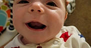 Sonny joined the competition — help win amazing prizes! baby, child, infant, smiling, happy, face, portrait, close_up, indoor, play_seat, baby_clothes, onesie, stars, colorful, playmat, seated, looking_at_camera, open_mouth, warm_lighting, photography