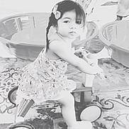Alejandra joined the competition — help win amazing prizes! bow, carpet, child, cute, dress, floor, footwear, furniture, girl, hair, indoor, patterned_rug, person, plastic_chair, play, portrait, smile, toy, tricycle, young_child