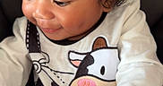 Kaison joined the competition — help win amazing prizes! toddler, child, curly_hair, smiling, white_clothing, cow_print, baby, cute, portrait, indoors, happy, infant, young_child, sitting, playful, closeup, person, clothing, face, hands