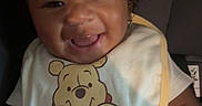 Kaison is registered to the contest to win money with this photo: baby, baby_clothes, bib, car_seat, child, clothing, curly_hair, cute, face, happy, indoor, infant, joy, person, portrait, seat, smiling, winnie_the_pooh, young, young_child