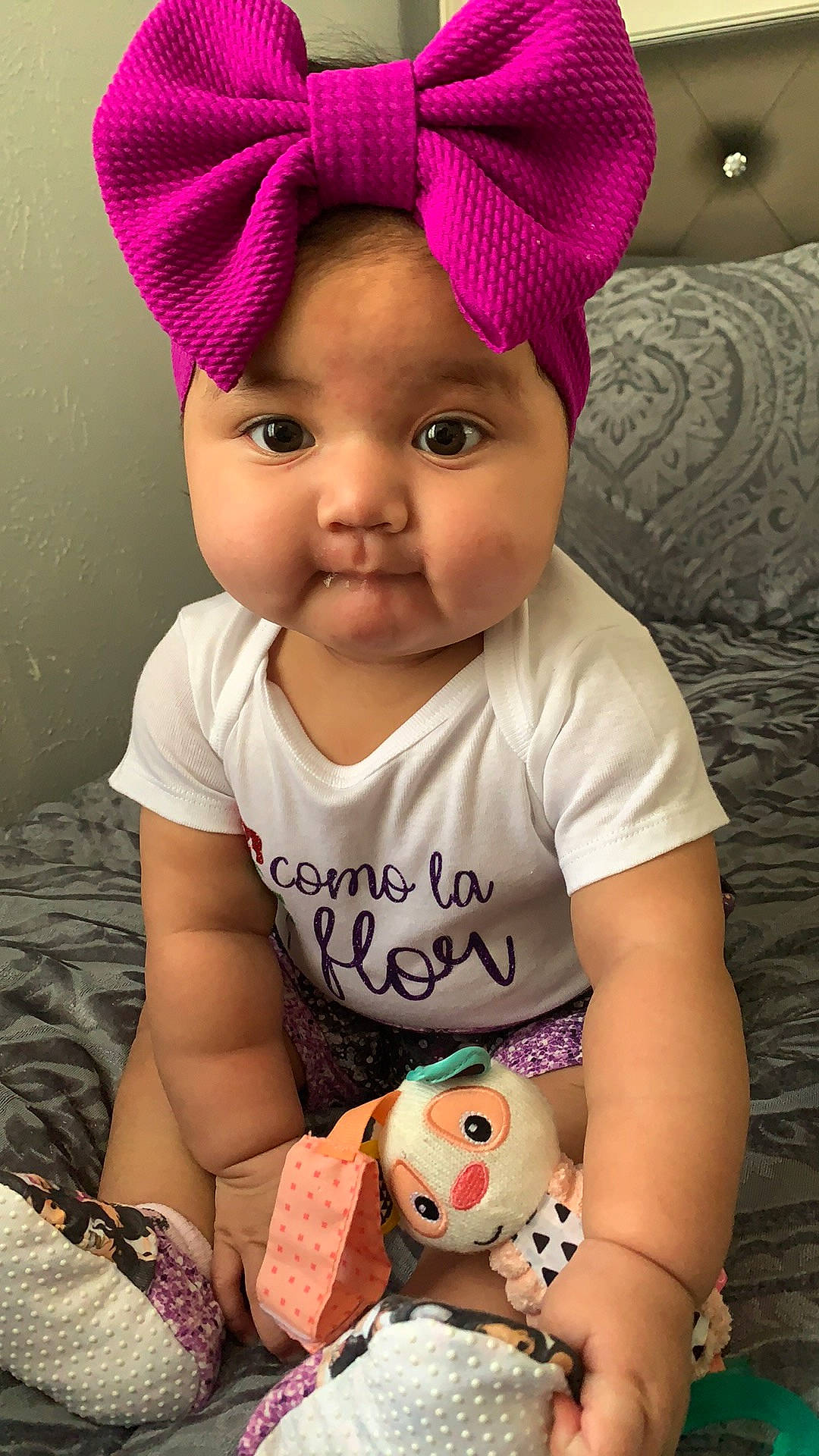 Marissa is registered to the contest to win money with this photo: baby, baby_toddler_clothing, cap, cheek, chin, eye, face, facial_expression, hair, happy, head, lip, mouth, nose, organ, person, pink, skin, sleeve, textile