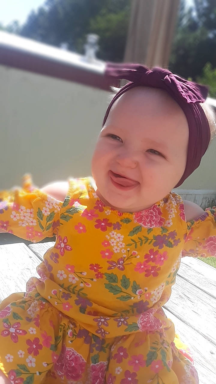 Malaysia is registered to the contest to win money with this photo: baby, baby_toddler_clothing, cheek, child, chin, event, eye, fun, grass, happy, headwear, human_body, iris, lip, magenta, pattern, person, pink, skin, sleeve