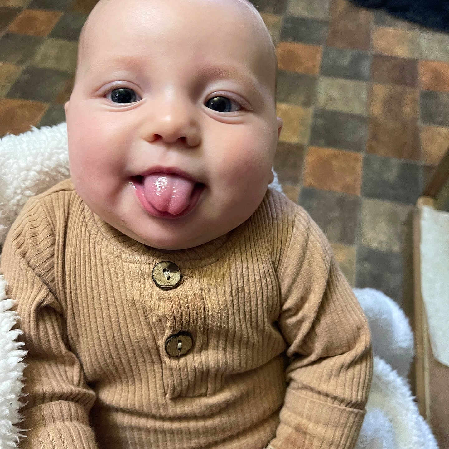 Eliana joined the competition — help win amazing prizes! baby, babylaughing, bodypart, clothing, coat, face, happy, head, jacket, knitwear, laughing, mouth, person, photography, portrait, sitting, smile, sweater, teeth, tongue