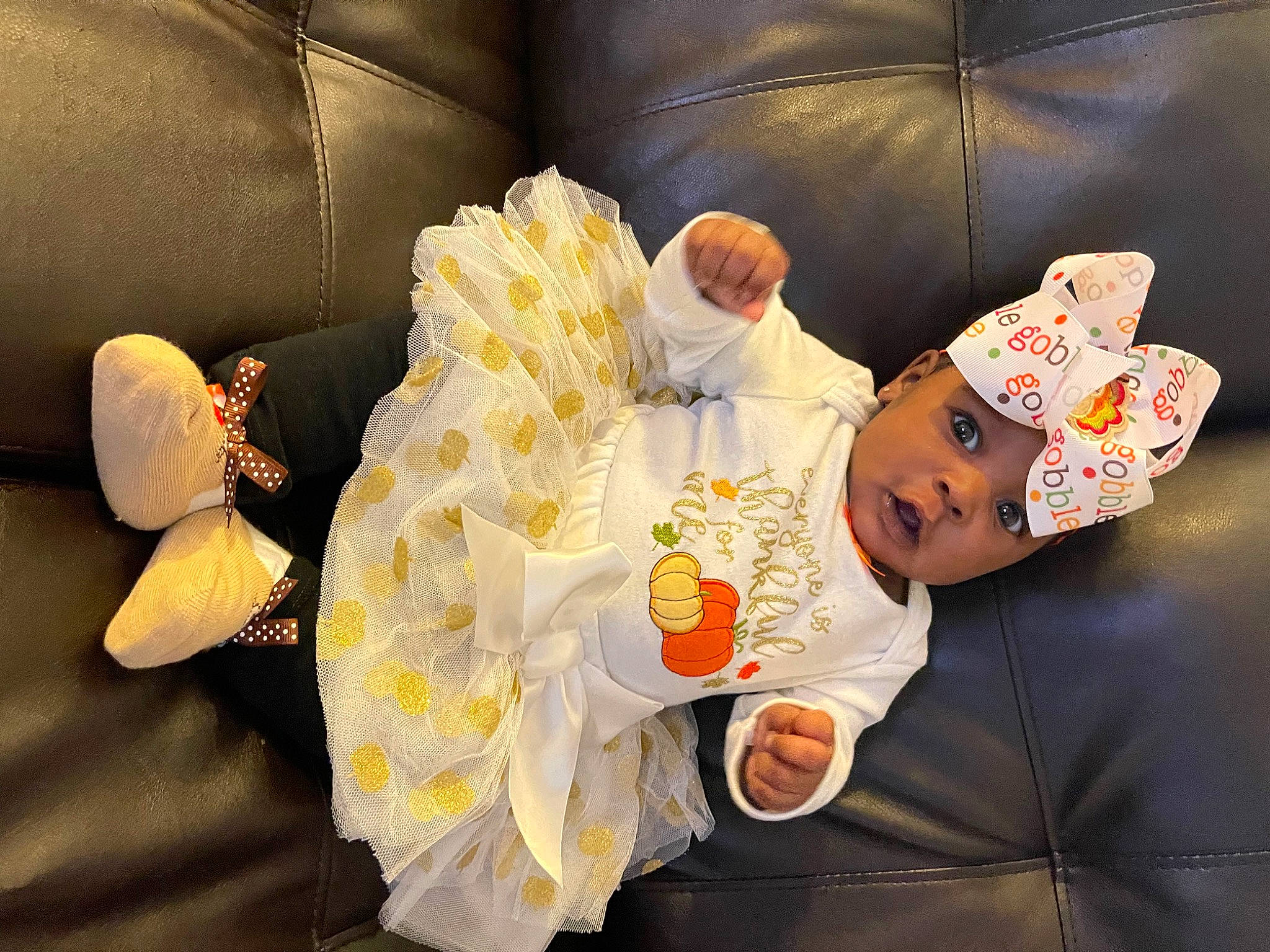 Lauryn is registered to the contest to win money with this photo: child, comfort, couch, event, fun, happy, hat, head, headwear, human, human_body, orange, peach, person, room, sitting, space, toddler