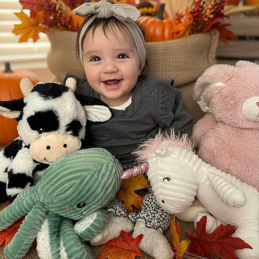 Zhamirah Zharih joined the competition — help win amazing prizes! autumn, baby, bear, burlap, child, cow, cozy, cute, decorations, fall_leaves, festive, happy, headband, indoor, octopus, plush_toy, pumpkin, sitting, smiling, unicorn