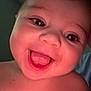 Emberly is registered to the contest to win money with this photo: baby, closeup, smiling, tongue_out, face, child, happy, skin, hand, infant, cute, portrait, expression, young, looking_at_camera, cheeks, indoors, warm_light, person, head