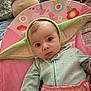 Emberly joined the competition — help win amazing prizes! baby, infant, child, green_hat, yoda_ears, pink_baby_seat, unicorn_pattern, floral_pattern, onesie, cute, wide_eyes, indoor, soft_toys, cozy, portrait, closeup, expression, baby_clothing, headgear, seated