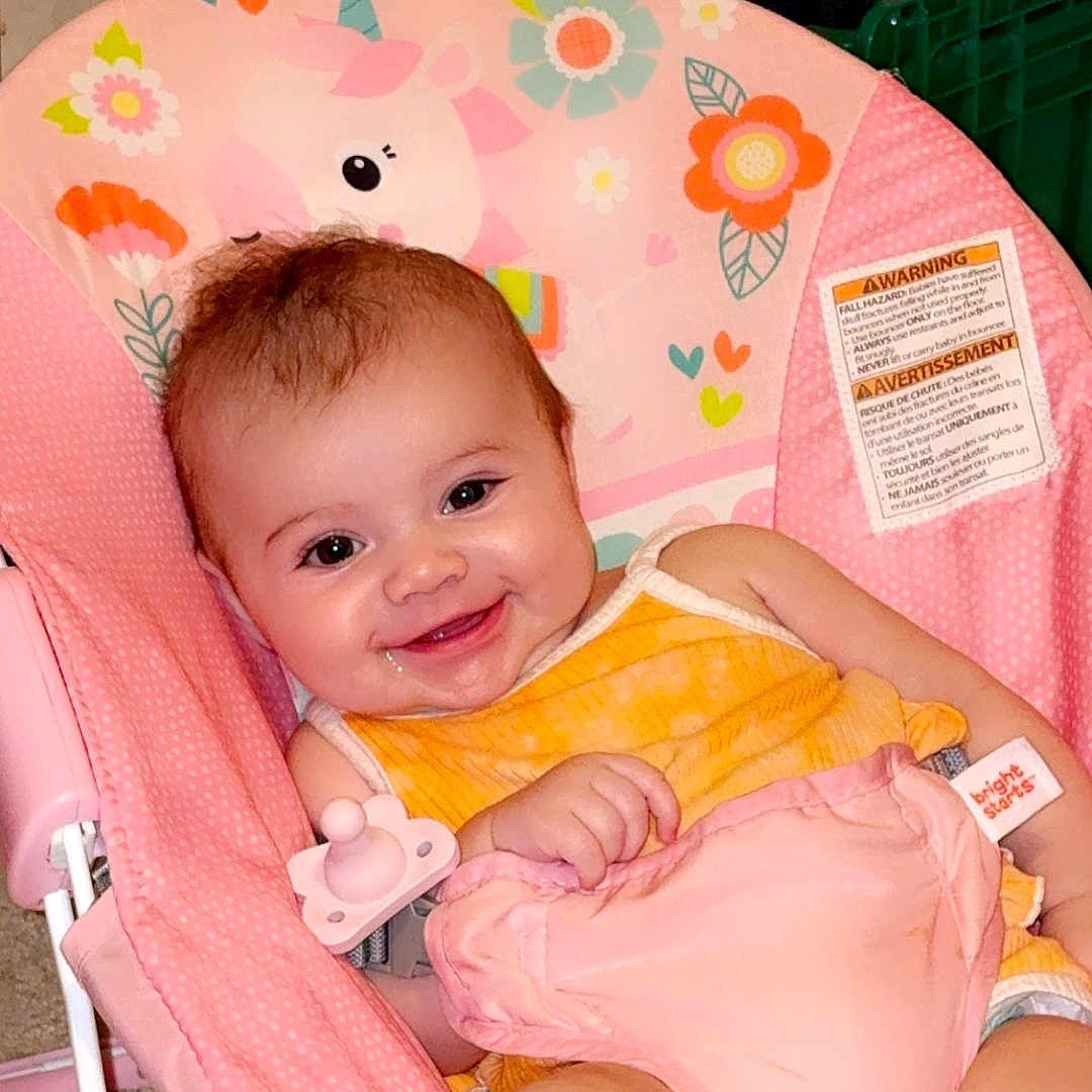 Emberly joined the competition — help win amazing prizes! baby, baby_seat, carpet, child, clothing, comfort, cute, fabric, happy, indoor, infant, pacifier, person, pillow, pink, seat, smiling, sock, toy, unicorn