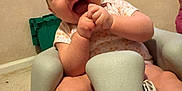 Emberly is registered to the contest to win money with this photo: baby, child, infant, foam_chair, indoor, carpet, clothing, smiling, hands, face, foot, playful, happy, person, seat, cute, toddler, skin, expression, young