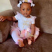 Namari is registered to the contest to win money with this photo: baby, birthday, brown_couch, child, couch, cute, festive, first_birthday, gold, happy, headband, indoors, jewelry, leggings, pink, portrait, sitting, smiling, tutu, white