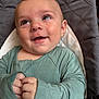 baby, infant, smile, face, hands, green_clothing, baby_seat, cute, child, portrait, happy, closeup, indoor, skin, eyes, expression, young_child, sitting, cozy, candid