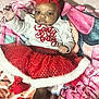 Dalylah is registered to the contest to win money with this photo: baby, infant, child, red_tutu, headband, blanket, polka_dots, holiday_outfit, cute, smiling, indoors, portrait, clothing, festive, soft_toys, bed, cozy, happy, person, christmas