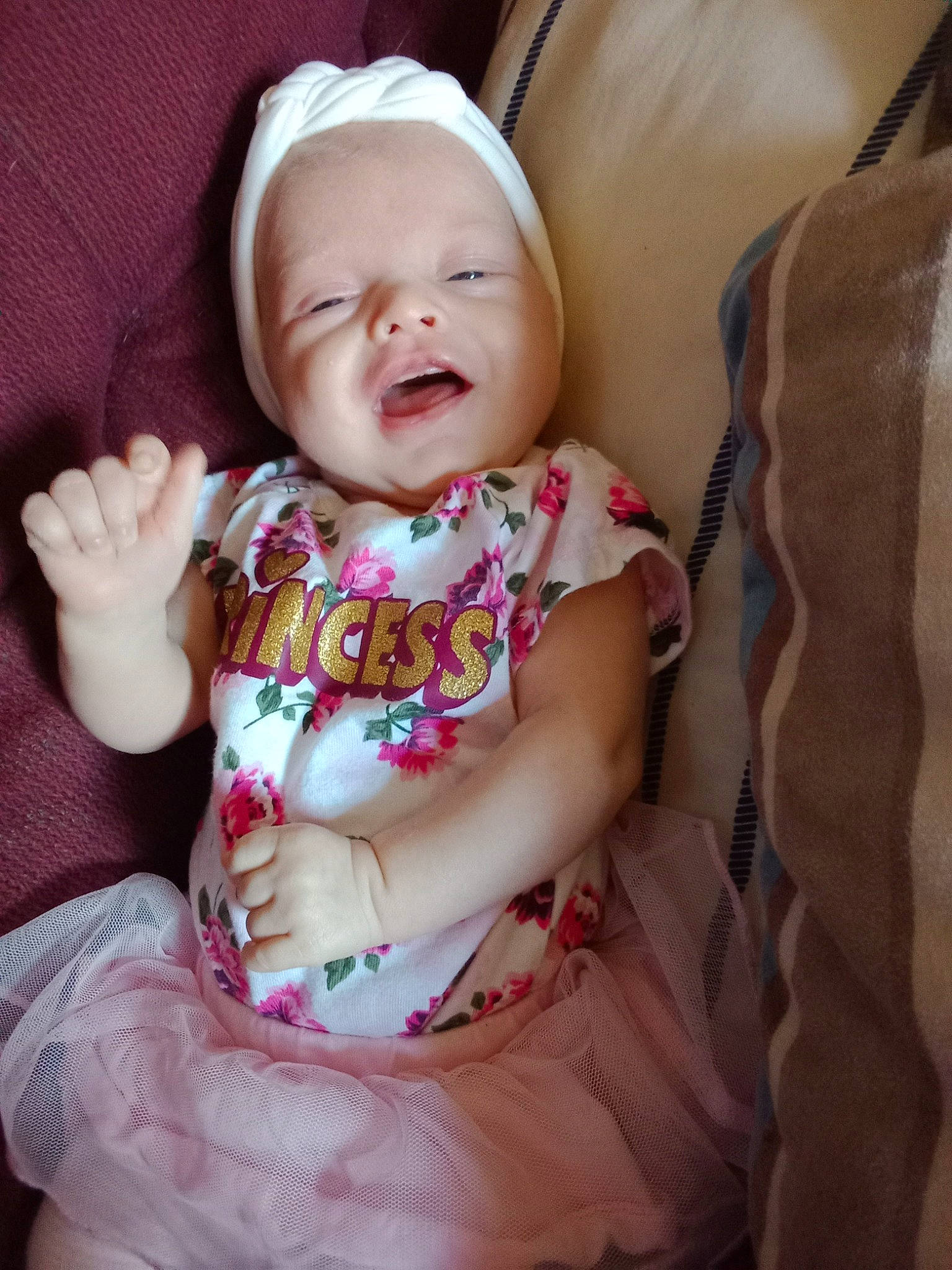 Avalynn is registered to the contest to win money with this photo: baby, baby_toddler_clothing, cheek, child, comfort, eye, finger, fun, hand, happy, iris, linens, pattern, person, pink, sitting, skin, sleeve, smile, textile