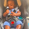 Amir is registered to the contest to win money with this photo: baby, infant, car_seat, sleeping, dumbbell, blue_clothing, white_socks, child, safety_harness, seat_belt, head_support, toy, indoor, close_up, cute, adorable, resting, infant_toddler, baby_gear, snugride_dlx