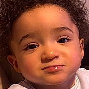 Noam a rejoint le concours — aidez-le/la à gagner de superbes lots ! child, toddler, curly_hair, face, portrait, expression, white_clothing, indoors, cute, young_child, baby_face, person, soft_lighting, close_up, skin, eyebrows, eyes, mouth, nostrils, head