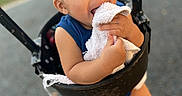 Michael joined the competition — help win amazing prizes! baby, blue_clothing, blurred_background, child, curly_hair, cute, feet, fun, happy, holding, legs, outdoor, park, person, playground, shoes, smiling, swing, toddler, towel