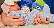 Sophia is registered to the contest to win money with this photo: child, baby, boy, infant, holding, indoor, pillow, blanket, sleepwear, toddler, family, love, care, portrait, sibling, cute, person, clothing, headwear, couch