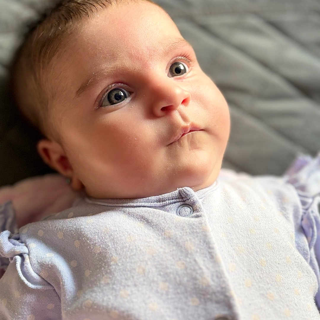 Olivia joined the competition — help win amazing prizes! baby, infant, face, eyes, onesie, clothing, polka_dot, portrait, close_up, cute, child, skin, head, soft_light, expression, newborn, sleepwear, indoors, quilted_background, baby_girl