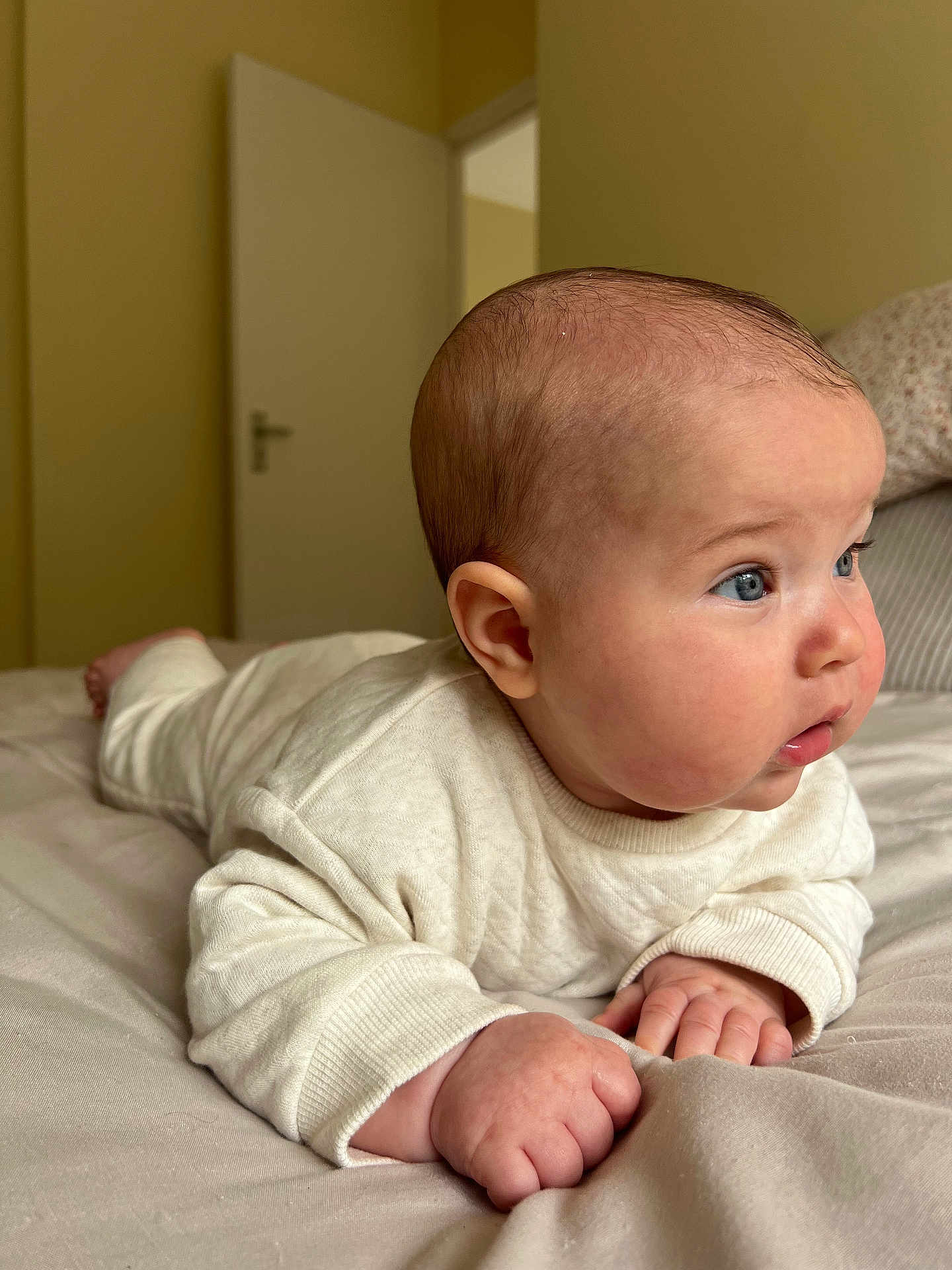 Franco Robert joined the competition — help win amazing prizes! baby, infant, tummy_time, bed, blanket, clothing, blue_eyes, chubby_cheeks, hands, face, head, indoor, neutral_colors, soft_light, curious, person, portrait, sleepwear, newborn, cozy