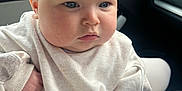 Franco Robert is registered to the contest to win money with this photo: baby, child, face, expression, sweater, clothing, indoor, car, seat, window, seatbelt, person, skin, head, cheeks, eyes, hands, soft_light, casual, portrait