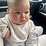 baby, child, face, expression, sweater, clothing, indoor, car, seat, window, seatbelt, person, skin, head, cheeks, eyes, hands, soft_light, casual, portrait