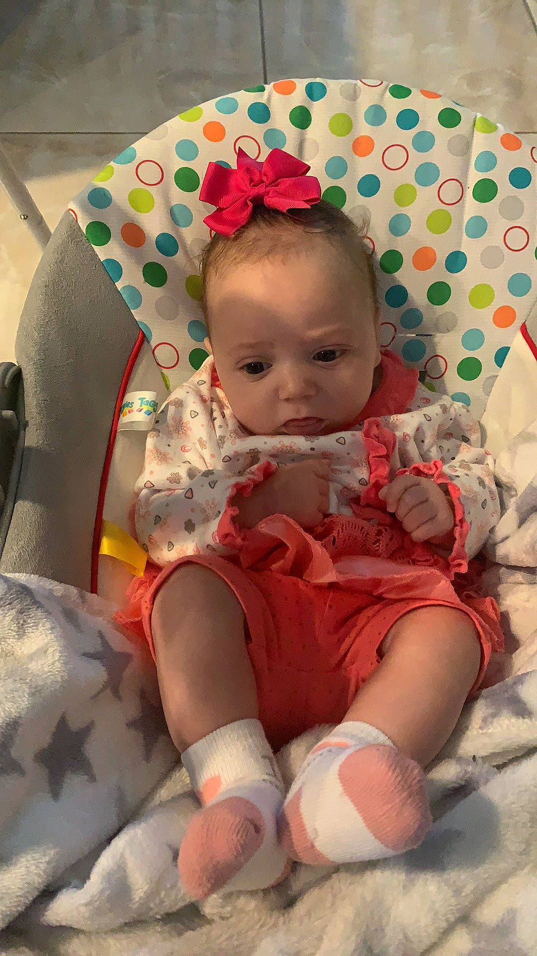 Gabrielle is registered to the contest to win money with this photo: baby, baby_toddler_clothing, chair, cheek, child, comfort, eye, face, hairstyle, head, human_body, iris, mouth, pattern, person, pink, product, skin, sleeve, thigh