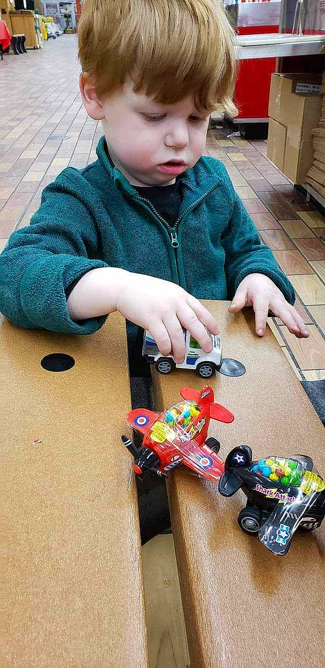 Vincent is registered to the contest to win money with this photo: baby_toddler_clothing, cabinetry, child, engineering, finger, flooring, fun, indoor_games_and_sports, leisure, nail, pattern, person, play, recreation, refrigerator, sharing, sitting, toddler, toy, toy_vehicle