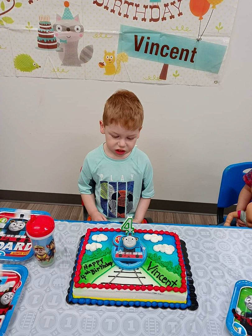Vincent joined the competition — help win amazing prizes! baked_goods, birthday, birthday_cake, birthday_party, cake, cake_decorating, cake_decorating_supply, chair, child, dessert, event, food, fun, green, person, sharing, sugar_cake, sweetness, t_shirt, table