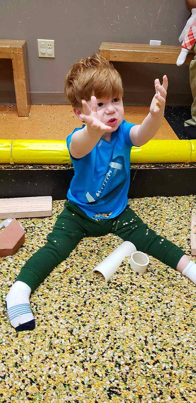 Vincent is registered to the contest to win money with this photo: active_pants, child, electric_blue, fun, grass, happy, human_leg, knee, leisure, outdoor_play_equipment, people_in_nature, person, recreation, shorts, sitting, sock, sportswear, t_shirt, thigh, toddler