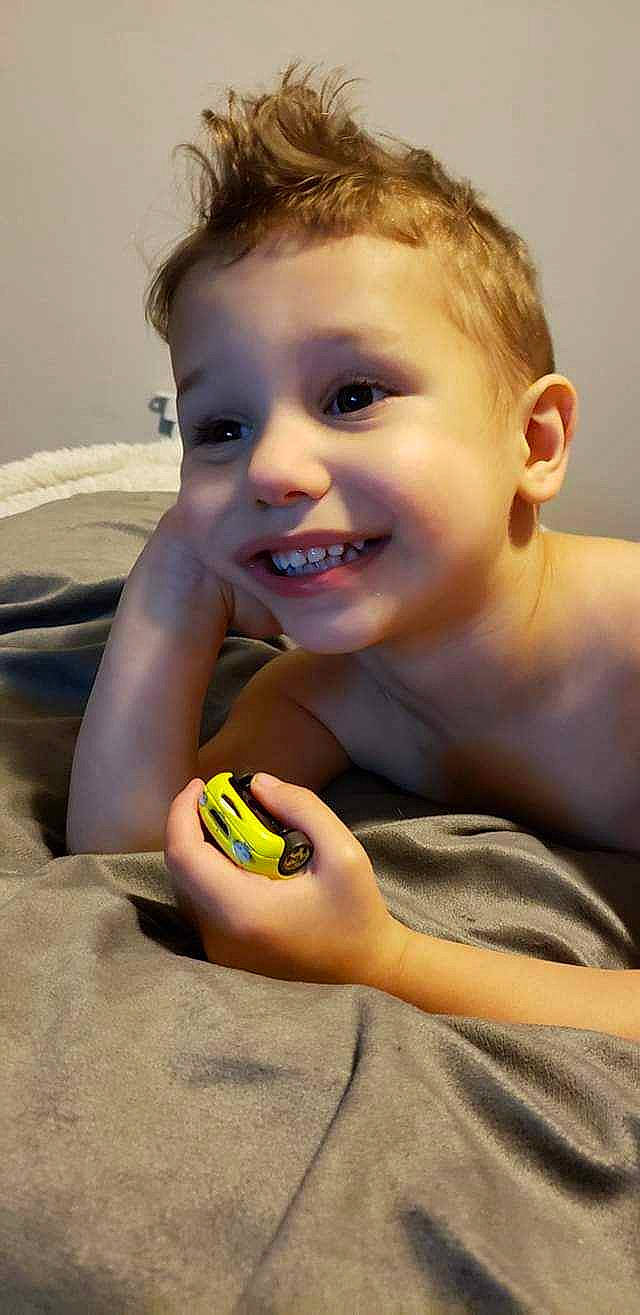 Sebastian is registered to the contest to win money with this photo: baby, cheek, chest, child, eye, finger, flash_photography, foot, fun, hand, happy, joy, mouth, nail, nose, person, sand, sitting, skin, smile